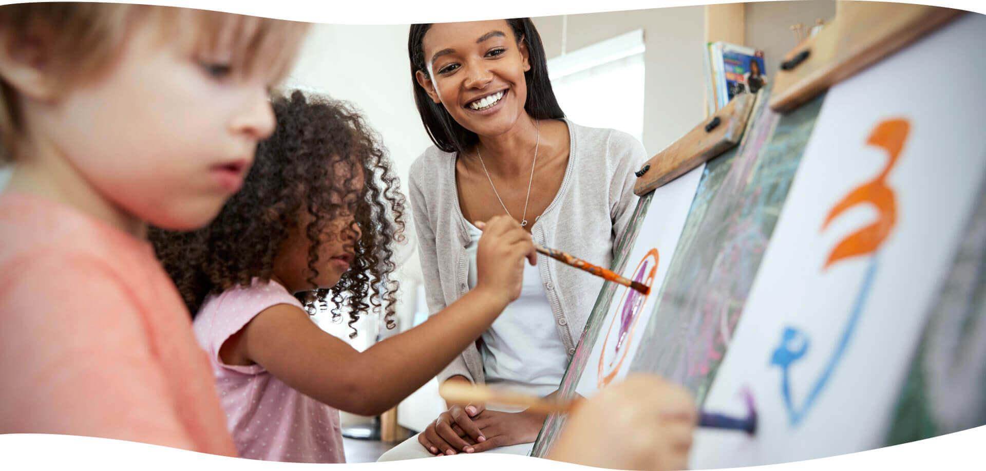 Girl child drawing on a board with chalk